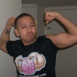 Ian Fernando Flexing with his Fat Man Unleashed T Shirt